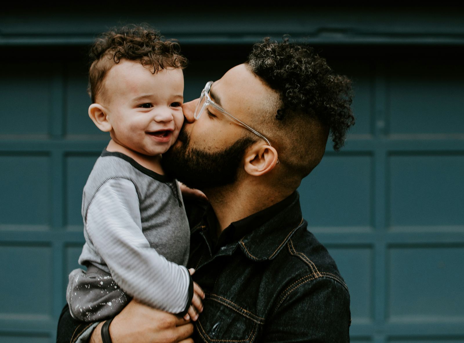 A father kissing his young son's cheek