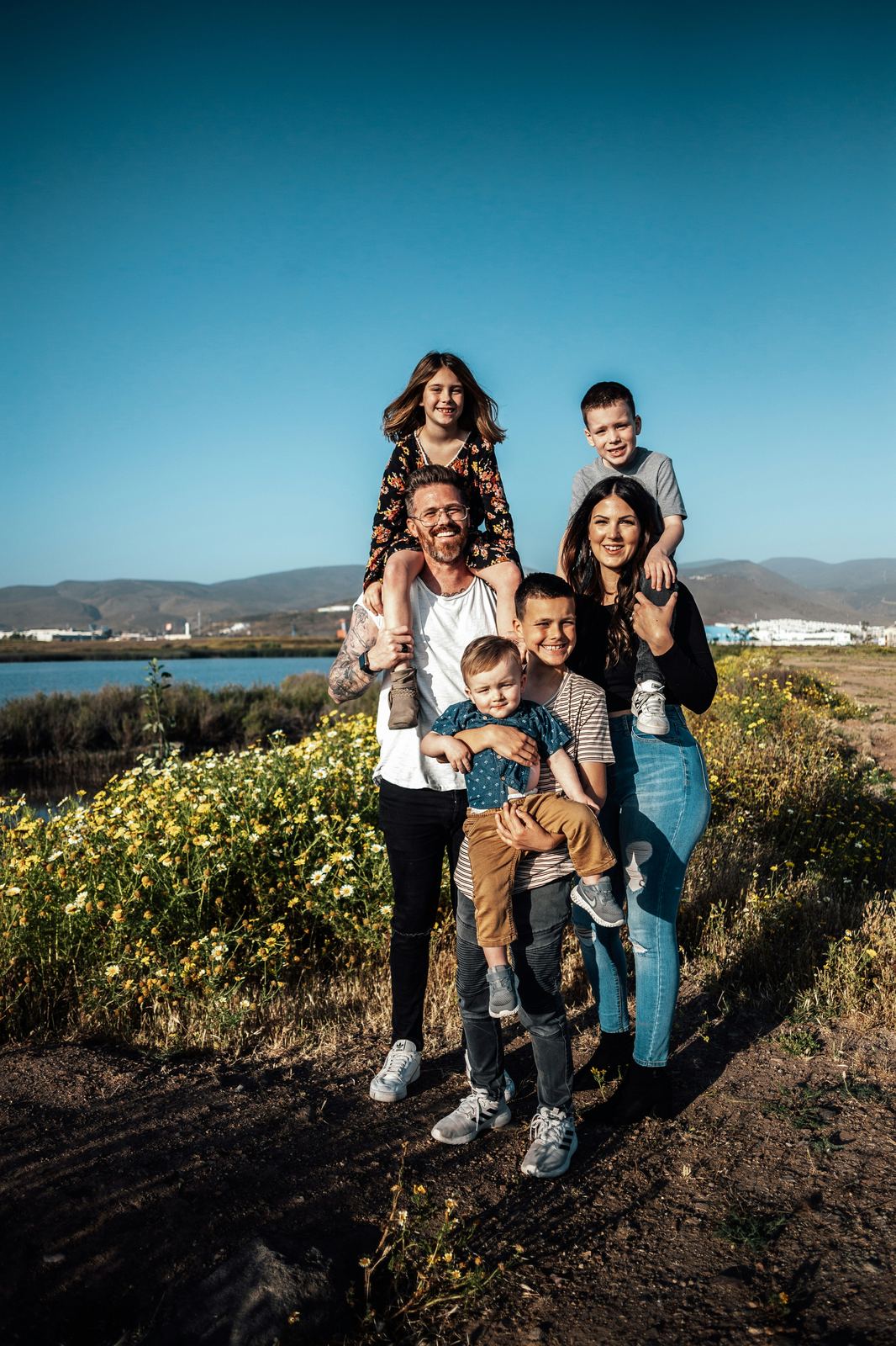 A family of six smiling together outdoors